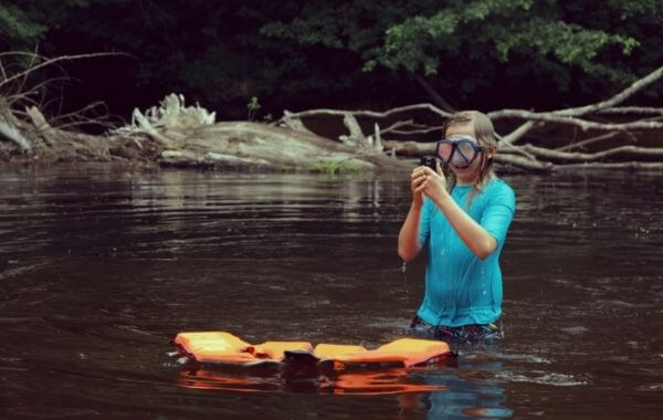 Vízálló telefon egy vízben álló gyerek kezében